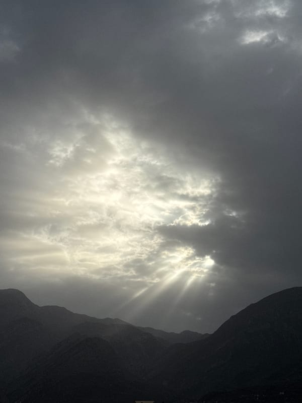Dramatic sunrise captured over Montenegro mountains amid overcast conditions