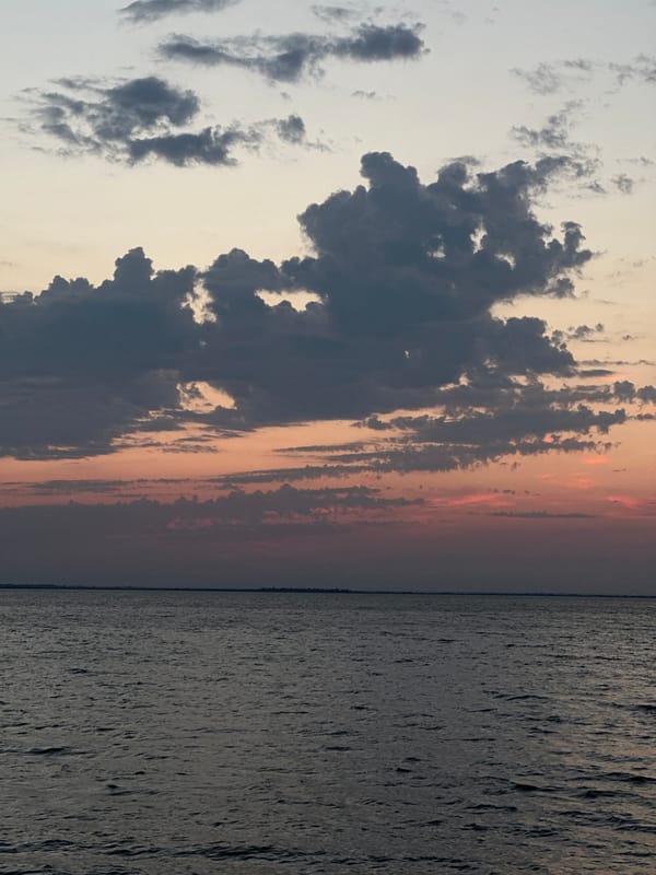 Sunset colors stretch across a calm Kazakhstan seascape