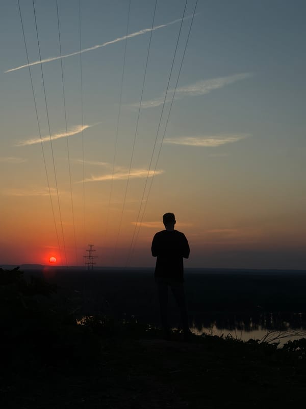 Couple photographs sunset near power lines in Noviy, Russia