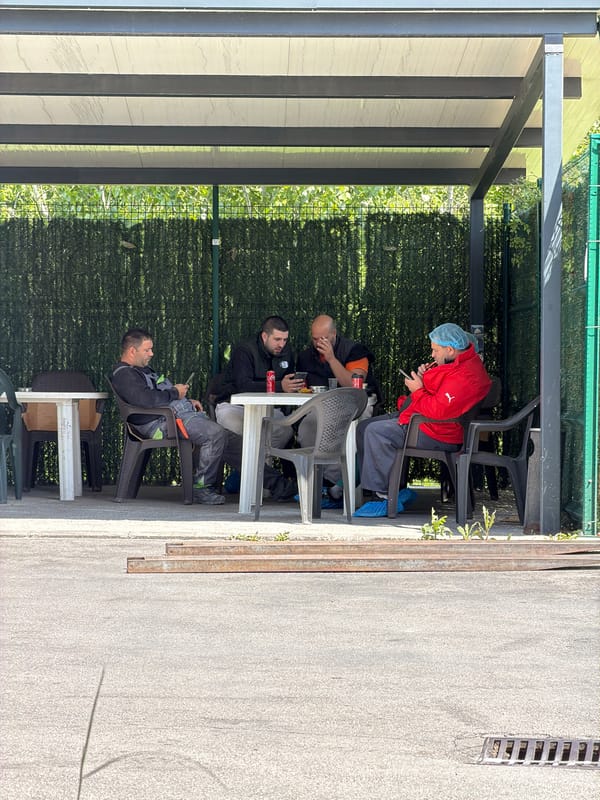 Four people gather at outdoor tables in Lozen, Bulgaria