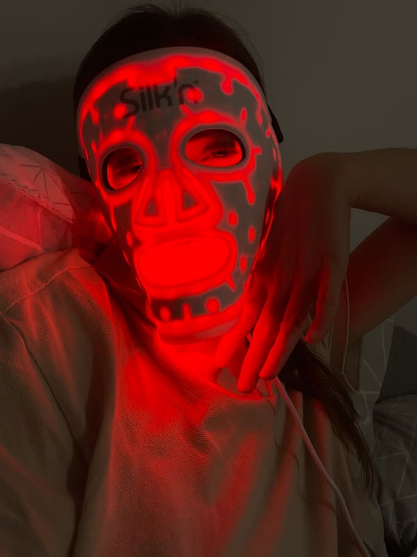 Person uses LED face mask during skincare treatment in Hévíz