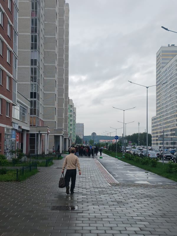 Rain-soaked morning street life documented across Yekaterinburg