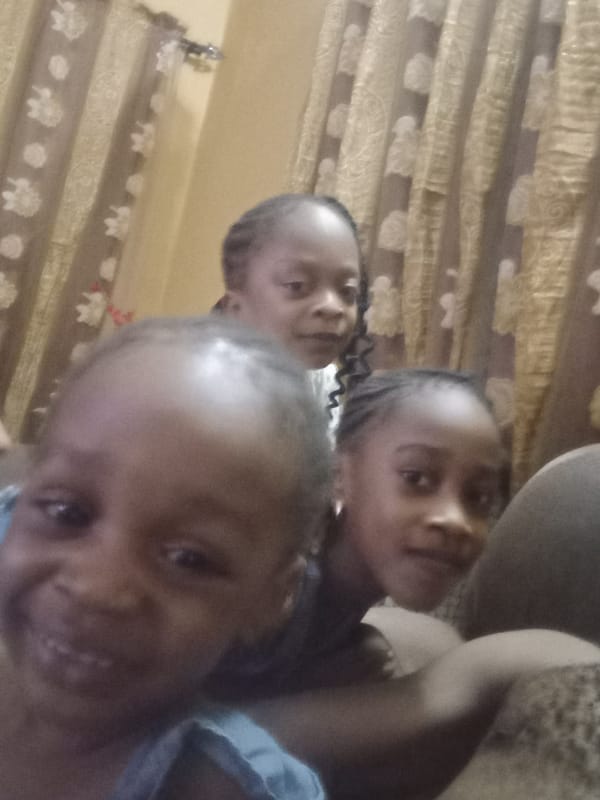 Family poses for photos at home in Nigeria