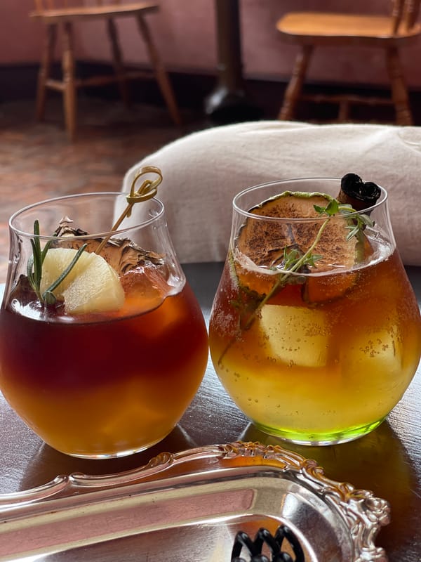 Drinks and a table set inside a atmospheric Bangkok interior