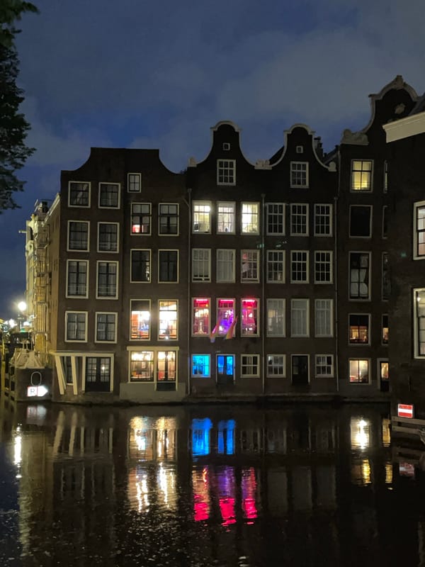 Amsterdam canal houses documented in nighttime scene