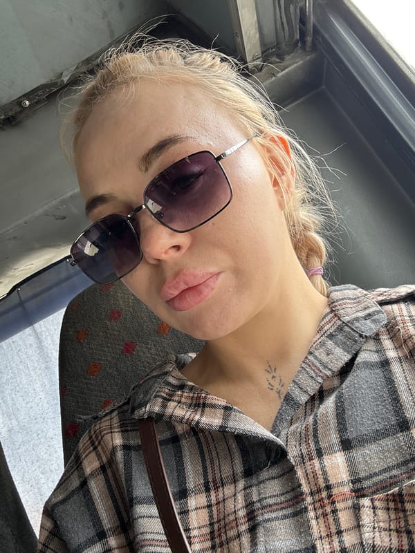 Woman travels with white dog through Megion, Russia