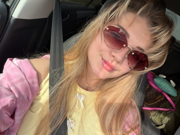 Woman in yellow top observed reclining in car in Russia