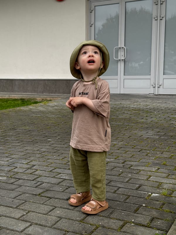 Child looks skyward on walkway in Sirius, Russia