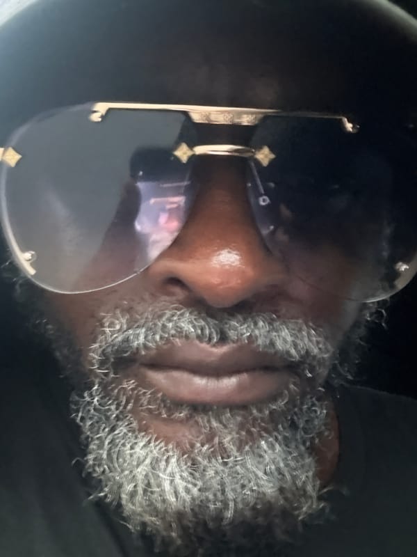 Close-up portrait detail, gold-accent sunglasses, Ado Nigeria