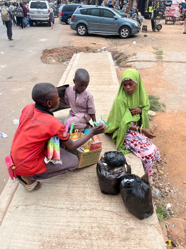 Daily street life documented across Jos, Nigeria during midday hours