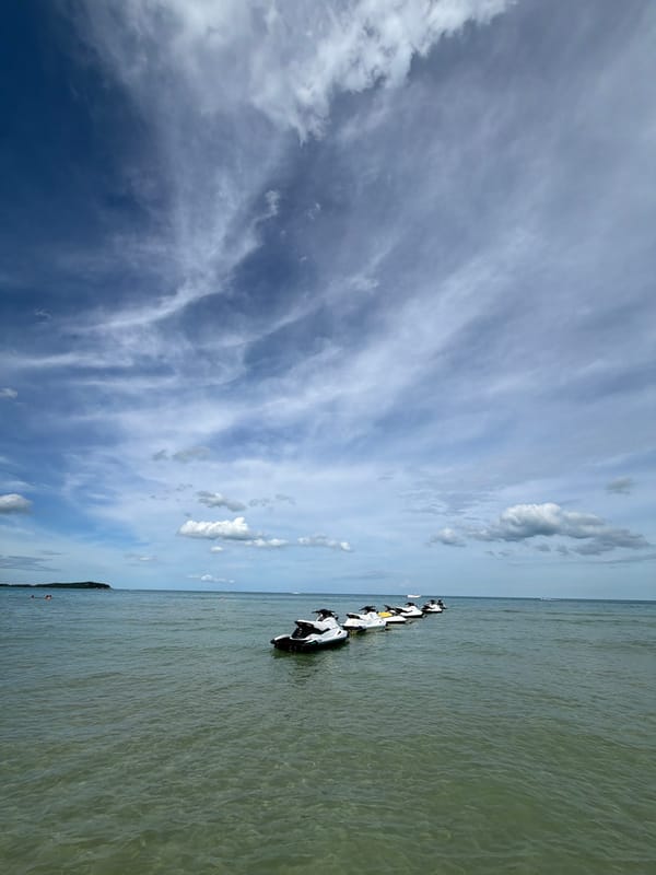 Jet skis lined up at Chaweng Beach on a cloudy morning
