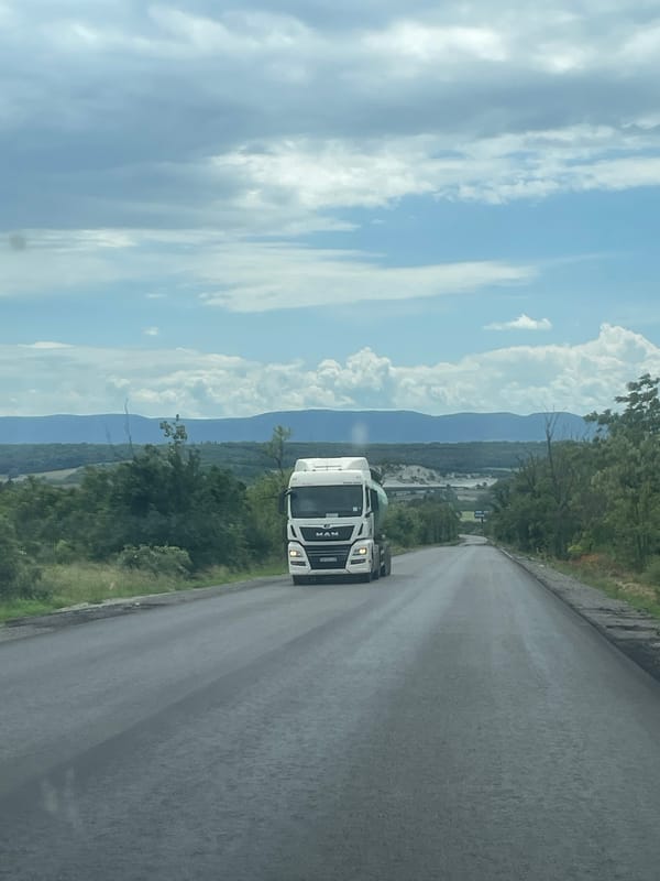 White truck travels through scenic Bulgarian countryside near Alvanovo