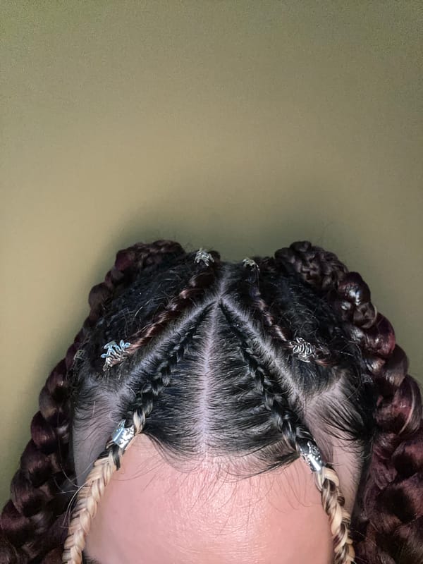 Elaborate braided hairstyle with silver charms spotted in Sofia