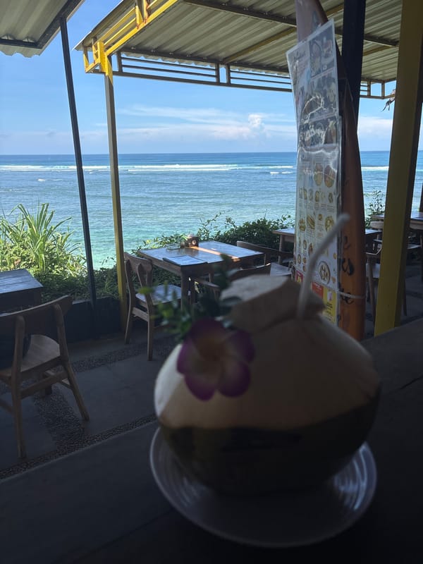 Early morning coconut drink enjoyed at Kuta Selatan beachside cafe