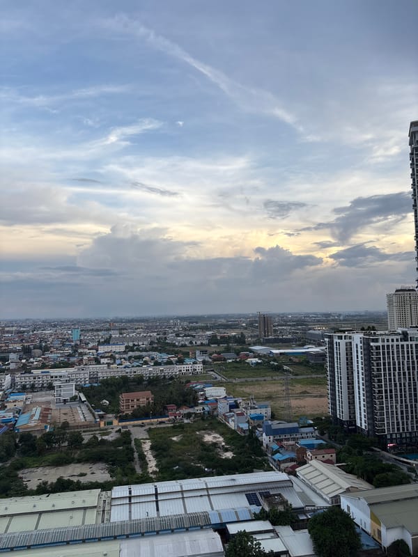 Rooftop pool views over Khan Mean Chey at golden hour