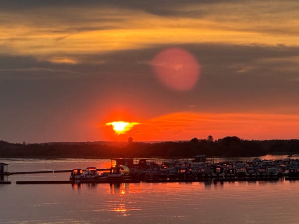 Vibrant sunset over Solikamsk waterfront draws evening crowds