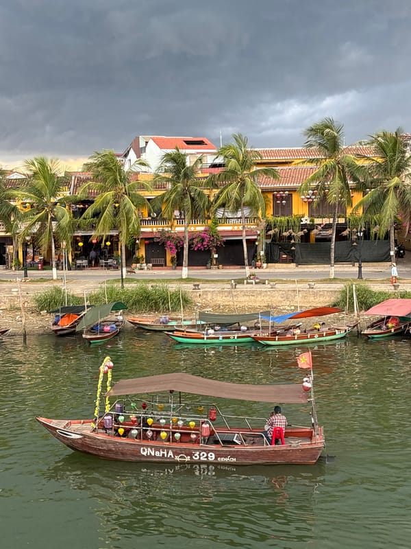 Canal life and stormy skies along Hội An's waterfront