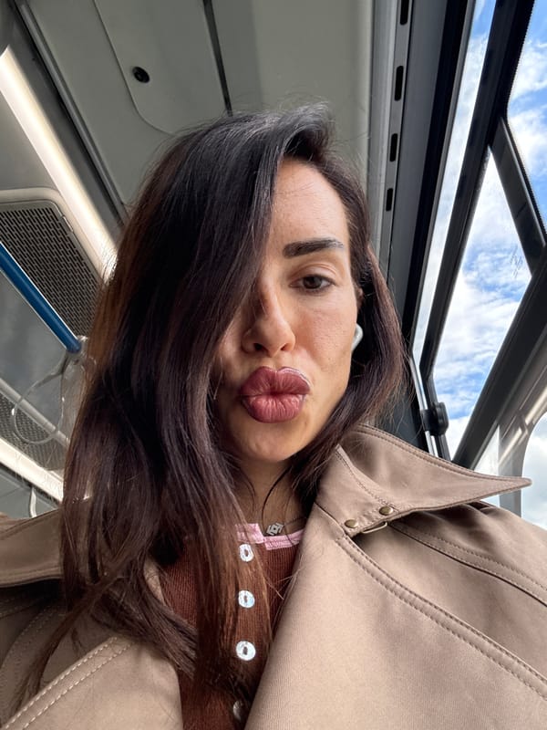 Selfie on Moscow public transit, trench coat and bold lip.