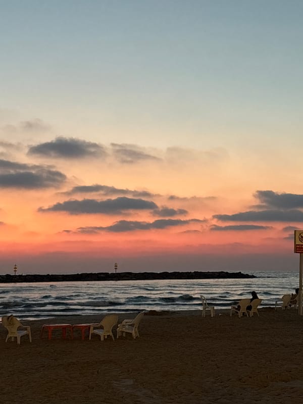 Tel Aviv beachgoers document sunset scenes and art installation