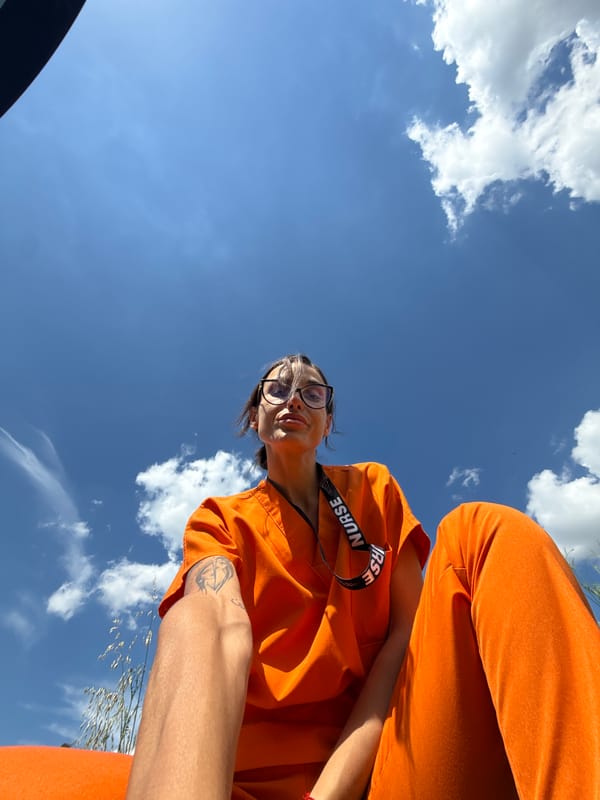 Nurse in orange scrubs takes casual photos around Pleven