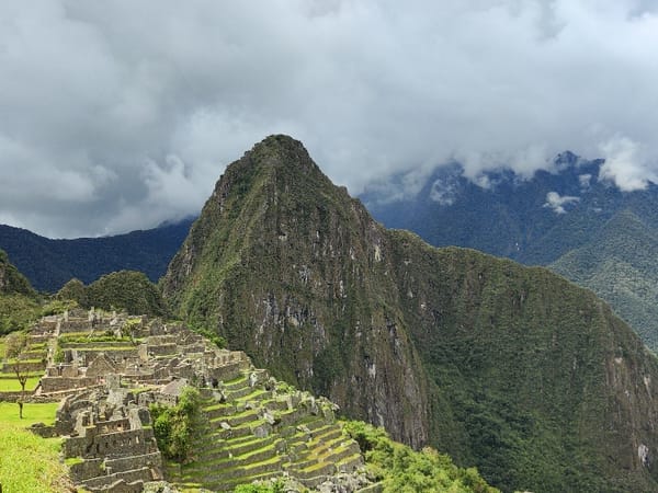 Tourists explore and photograph Machu Picchu ruins in Peru