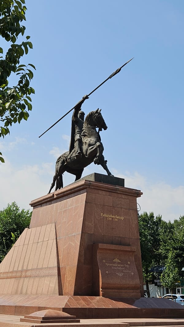 Raimbek Batyr statue and red roses in Almaty