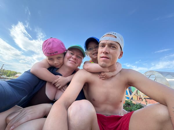Family enjoys outdoor time with cat in Chaikovsky