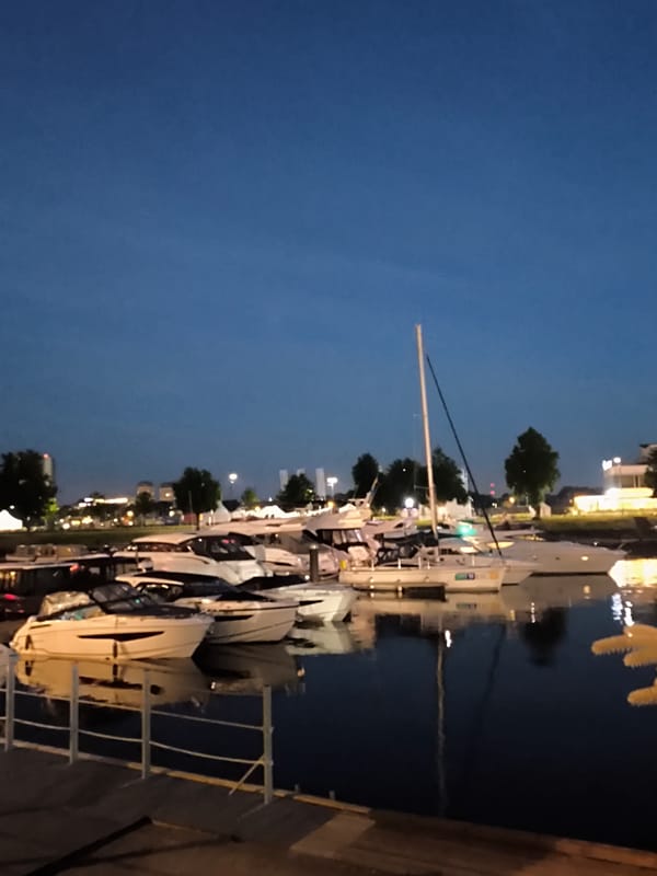 Riga marina at night, boats docked on still water