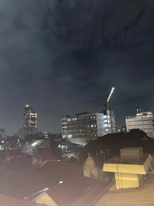 Jakarta skyline captured at dusk with construction activity visible