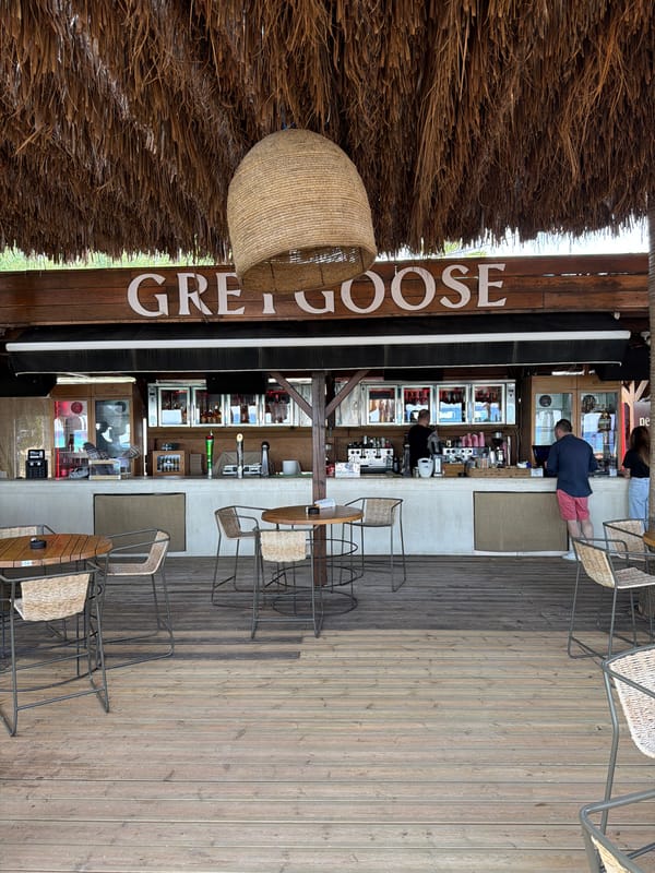 Thatched beach bar and loungers in Nea Peramos, Greece