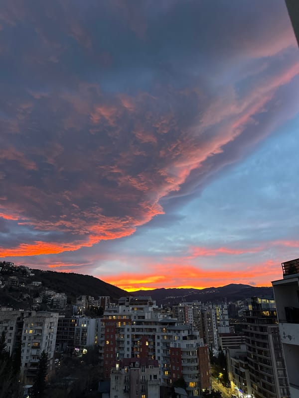 Dramatic sunset illuminates Tbilisi skyline with fiery colors