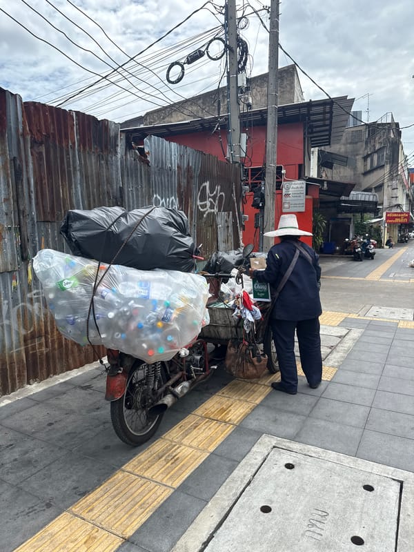 Bangkok street life: traffic, back alleys, and a flag on the sidewalk