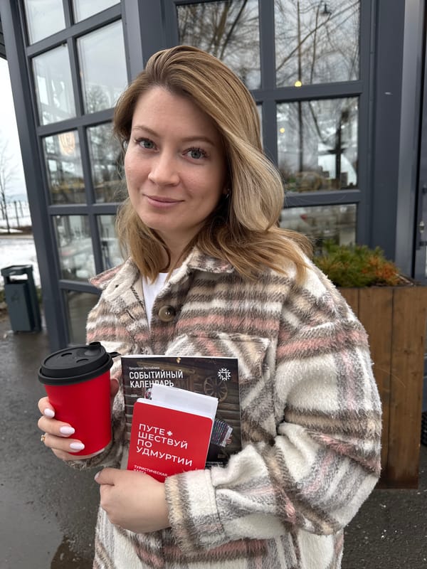 Woman reviews Udmurtia tourism materials outside Votkinsk cafe