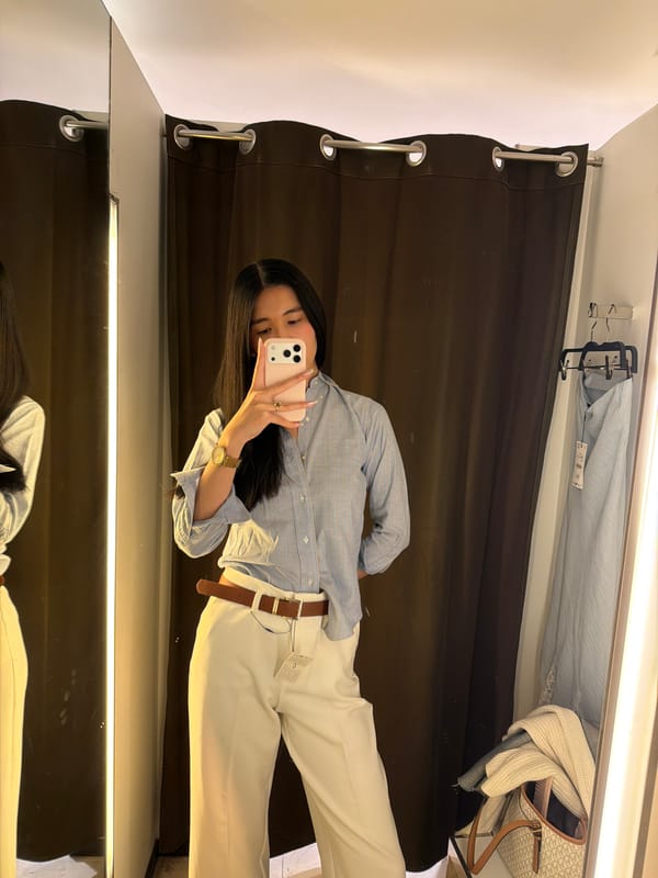 Person takes selfie in Paris store fitting room