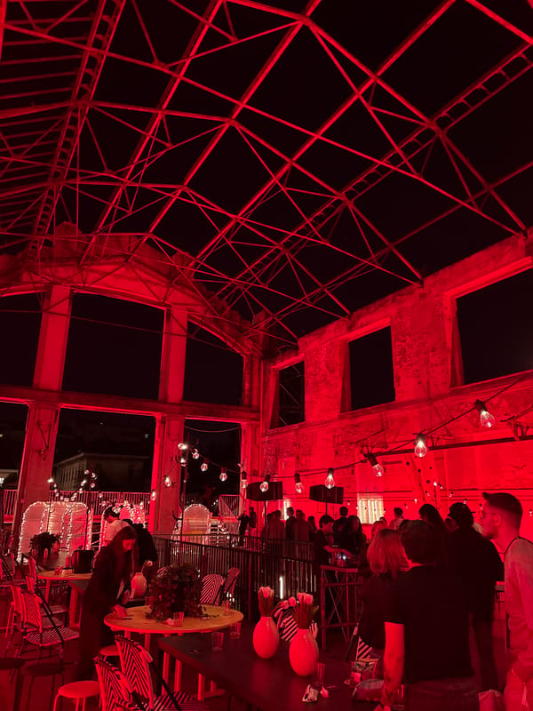 Social gathering at red-lit Milan rooftop bar draws attendees