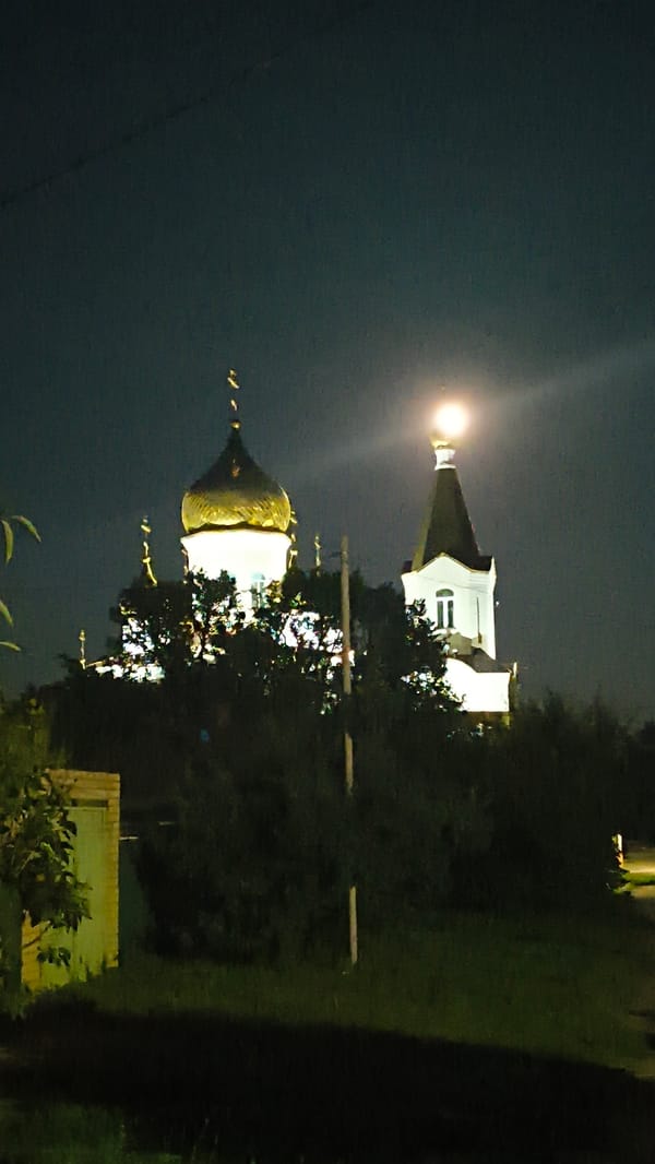 Nighttime streets and lit-up Orthodox churches in Mikhaylovka