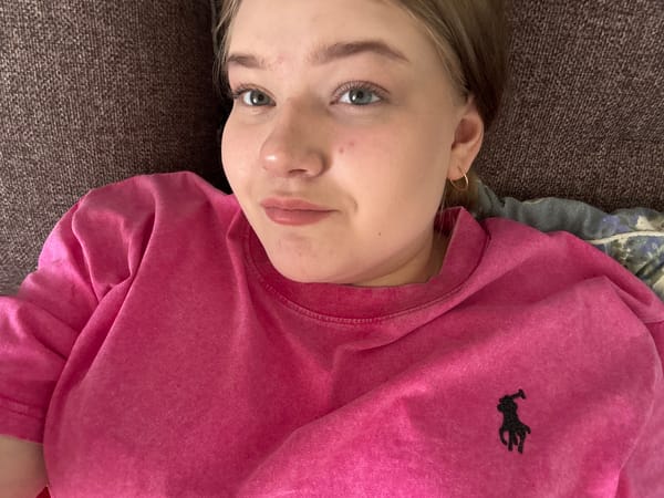 Woman takes indoor selfies in pink shirt, Foki Russia
