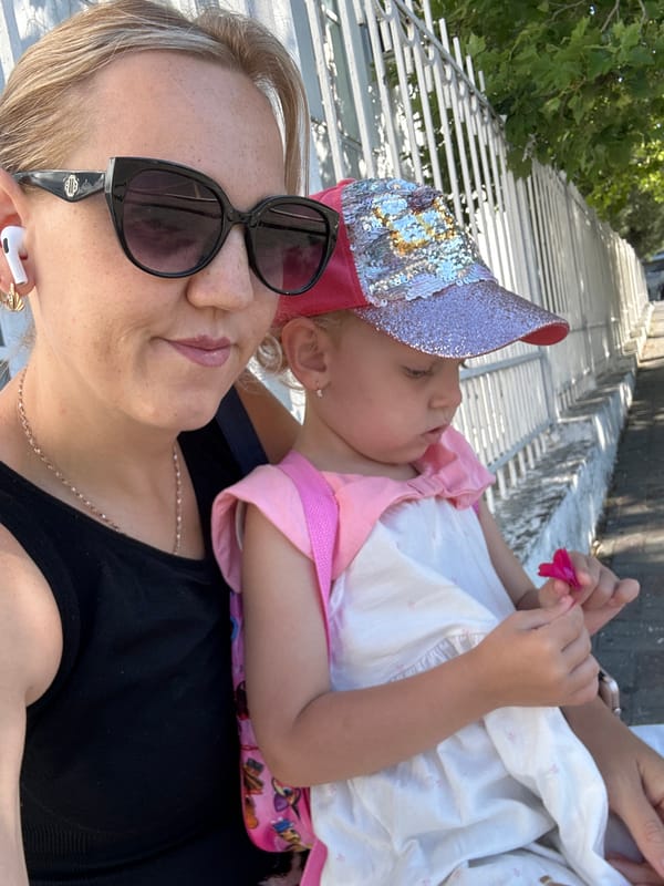 Holding a child outdoors in an urban setting