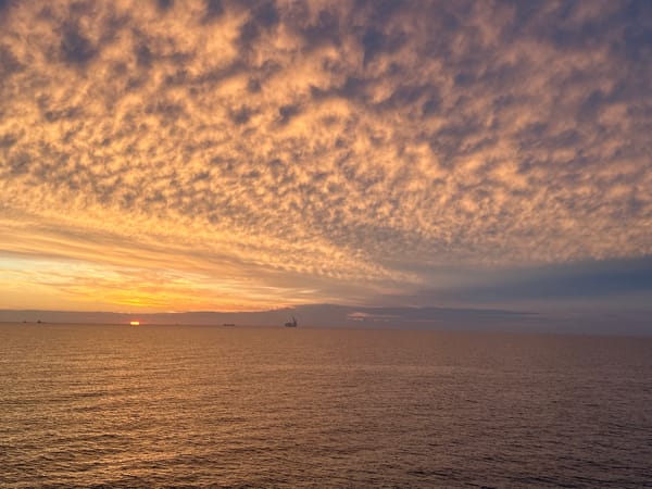 Dramatic cloud formations observed over seascape at sunset