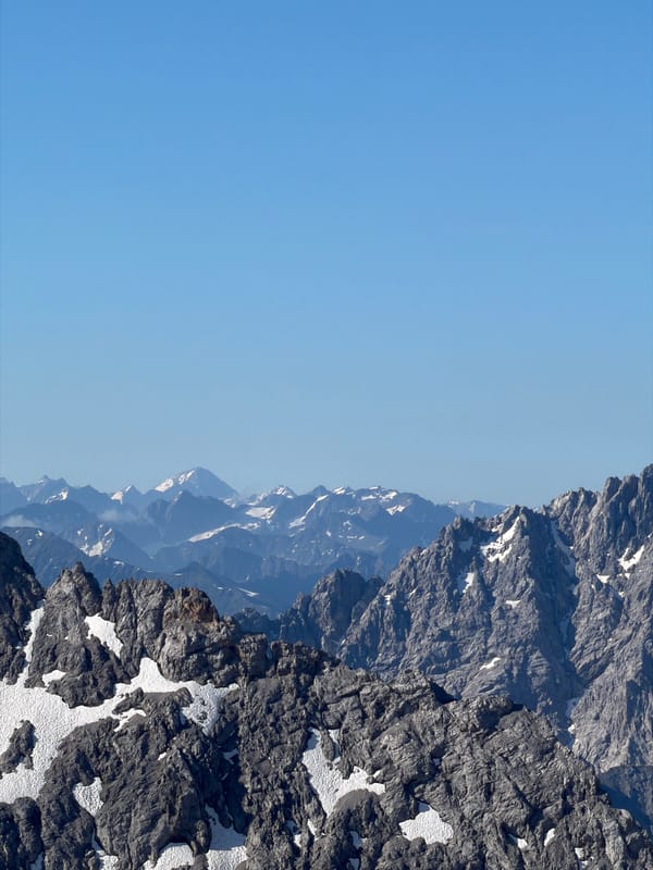 Snow-dusted alpine rocks under clear skies near Garmisch-Partenkirchen