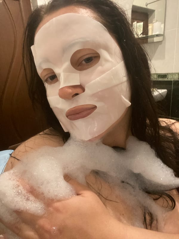 Person enjoys facial mask during bubble bath in Sochi