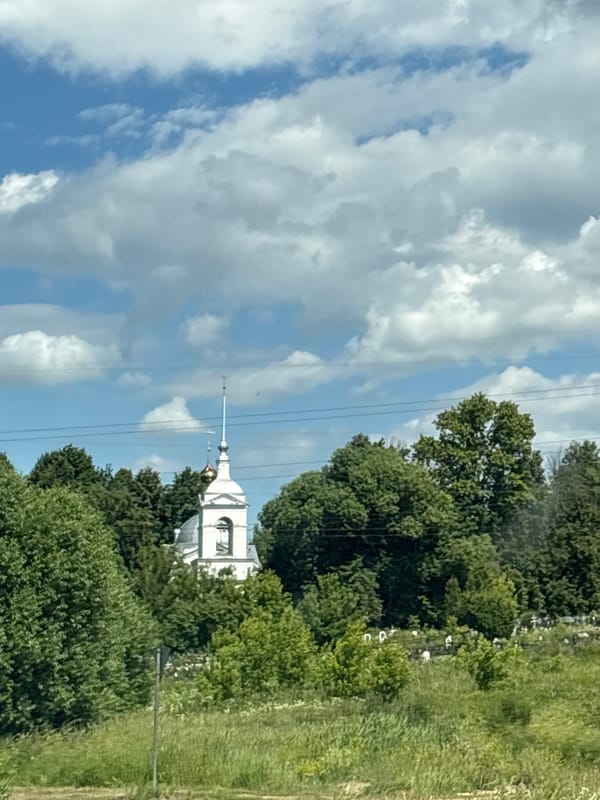 Orthodox church and village signage in Petrovskoye, Yaroslavl Oblast