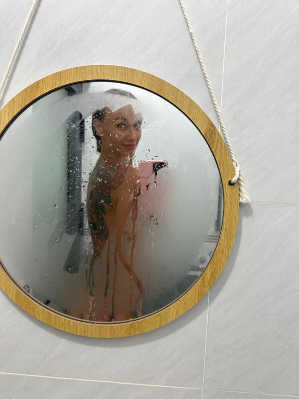 Person documents bathroom selfies in steamy mirror, Mũi Né