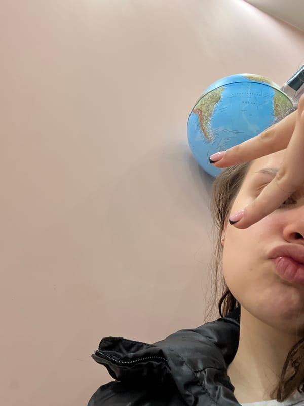 Person poses with small globe in artistic portrait