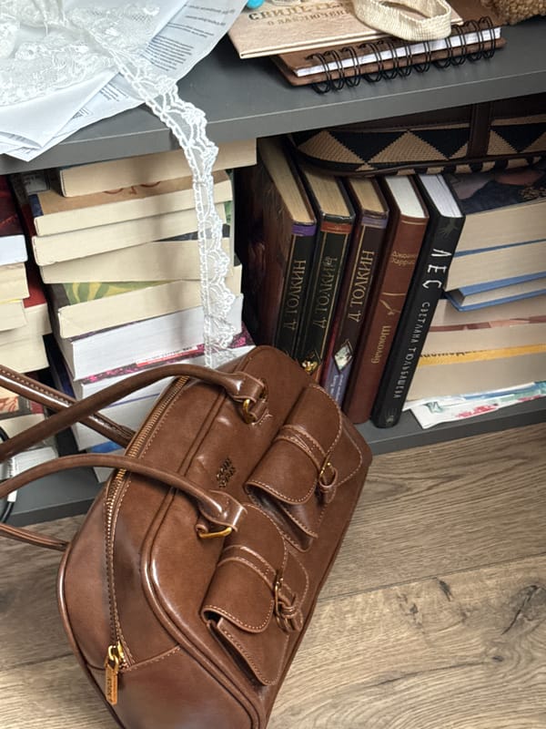 Woman takes selfie near handbags and books in Krasnodar home