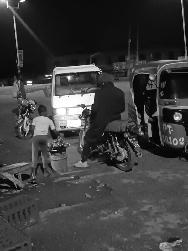 Night market bustling with vendors, vehicles in Bukuru Nigeria
