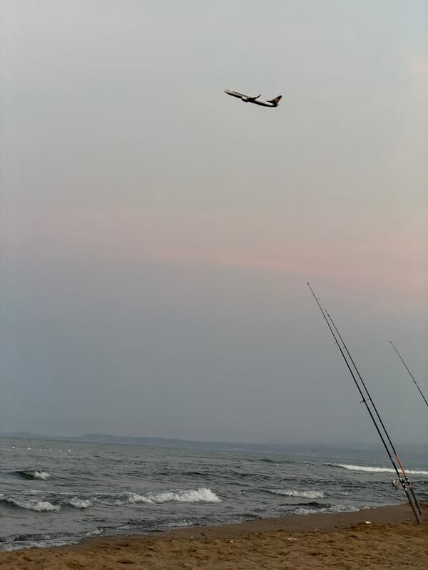 Evening beach scenes captured along Catania coastline with Mount Etna backdrop