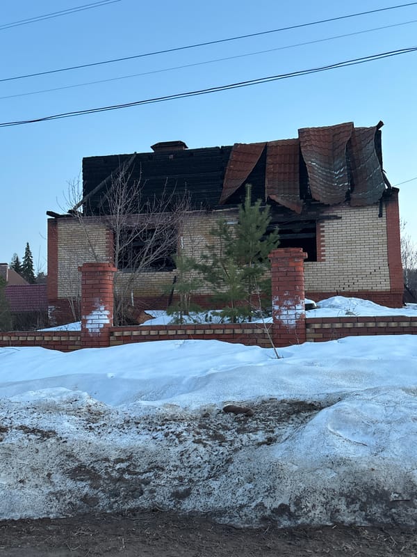 Fire-damaged house and twilight moon captured in Chaikovsky