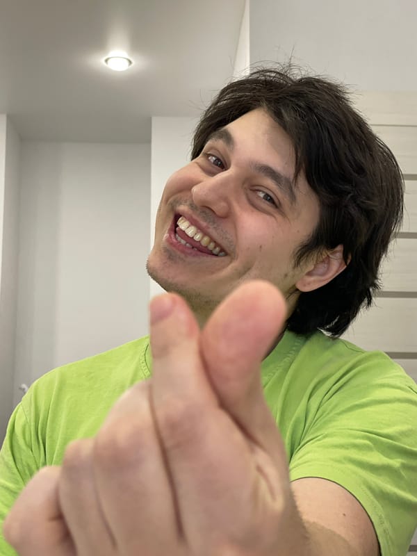 Man in lime shirt points at camera in Izhevsk