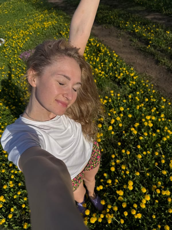 Woman rests peacefully in dandelion field in rural Russia